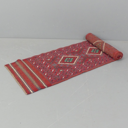 2289 - A red ground meshwani runner, 242x58cm.