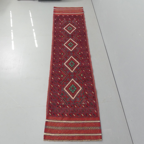 2289 - A red ground meshwani runner, 242x58cm.