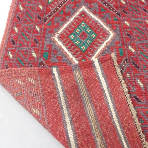 2289 - A red ground meshwani runner, 242x58cm.