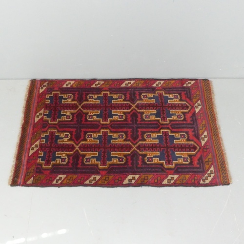 2290 - A red-ground Baluchi rug. 135x84cm.