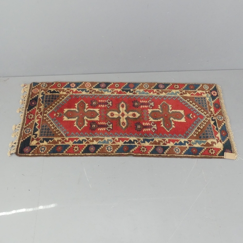 2292 - A red-ground Caucasian rug. 178x78cm.