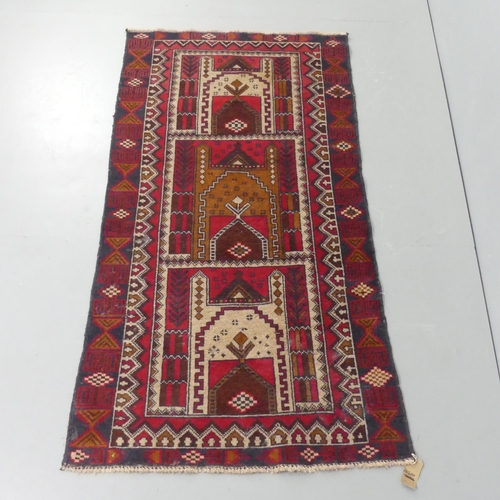 2298 - A red-ground Persian rug. 190x102cm.