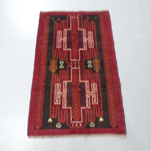 2302 - A red ground Baluchi rug, 140x85cm.