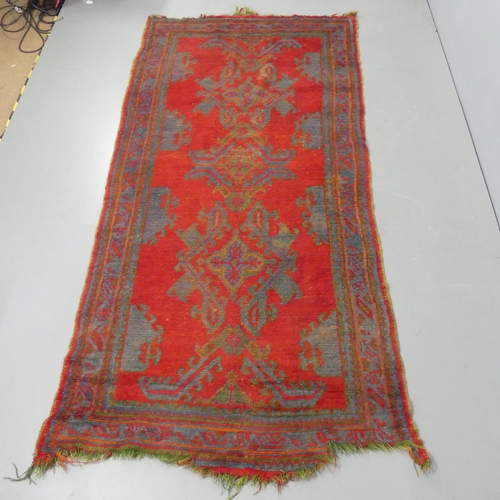 2313 - A red-ground Persian carpet. 282x126cm.