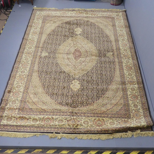 2319 - A machine-made cream-ground Tabriz carpet. 298x200cm.