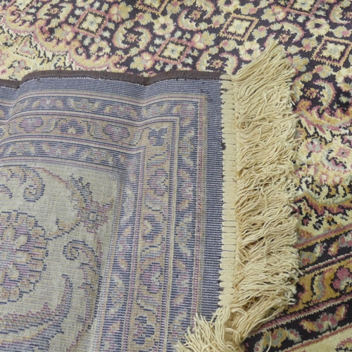 2319 - A machine-made cream-ground Tabriz carpet. 298x200cm.