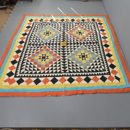 2327 - A patchwork quilt with geometric designs. 217x217cm.