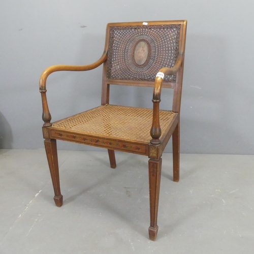 2503 - An antique Regency style bergere chair, with cane panelled back and seat, and painted decoration.