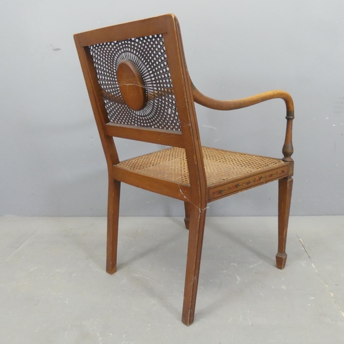 2503 - An antique Regency style bergere chair, with cane panelled back and seat, and painted decoration.