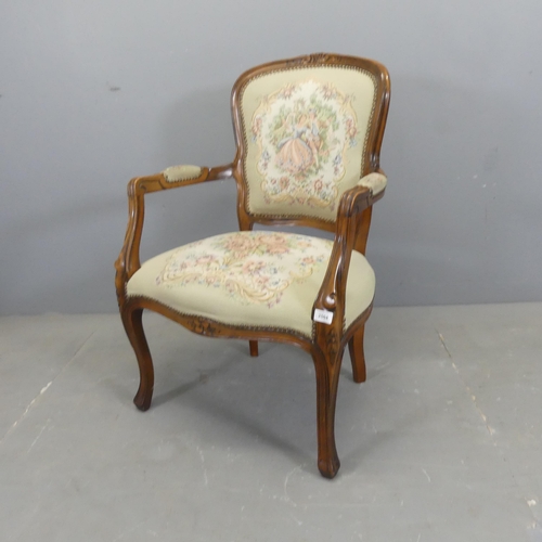 2504 - A French mahogany and upholstered open arm salon chair.