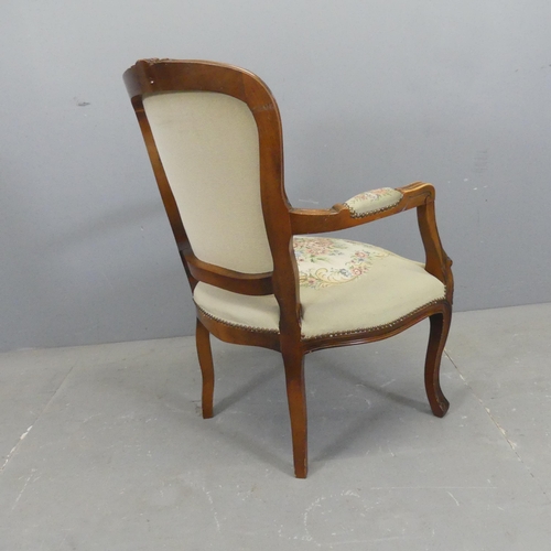 2504 - A French mahogany and upholstered open arm salon chair.