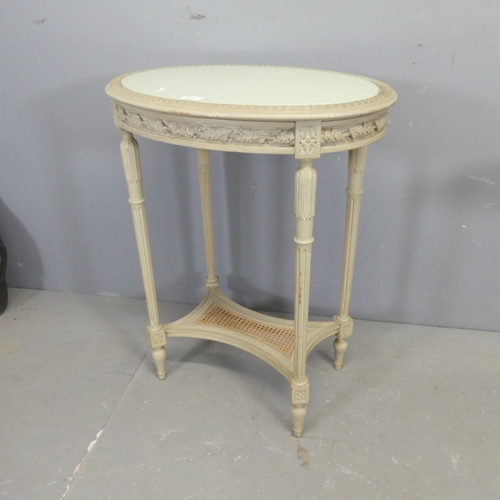 2513 - A modern French painted oak oval two-tier side table, with inset glass top, carved decoration and ca... 