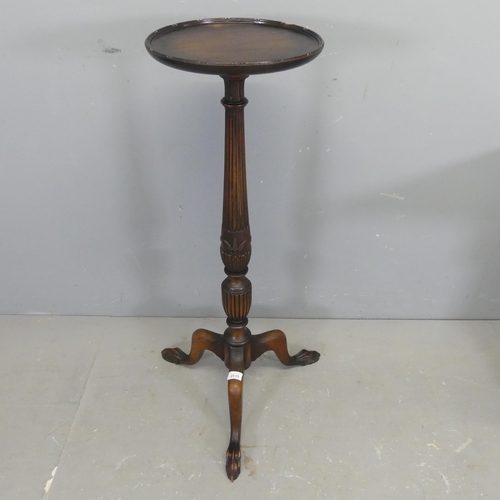 2515 - A reproduction mahogany torchere, with carved column and tripod base. Height 94cm.