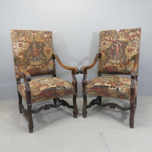 2522 - A pair of French oak and needlepoint upholstered open arm chairs.