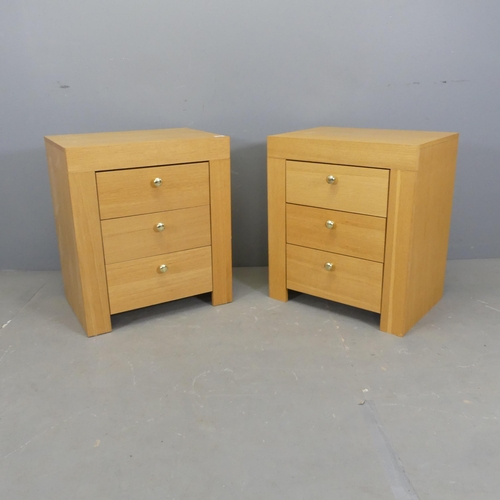 2527 - A pair of modern light-oak veneered three-drawer bedside chests. 59x67x40cm.