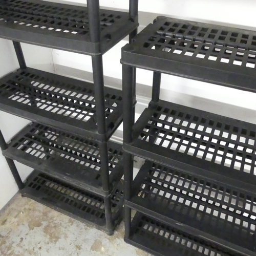 2542 - Two modern plastic modular shelving units, with a total of nine shelves including two bases. Largest... 