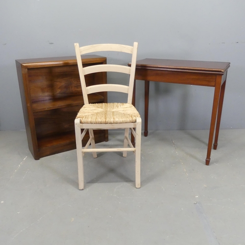 2547 - An Edwardian mahogany folding tea table, 69x72x35cm, a small bookcase and a rush seated chair, impre... 