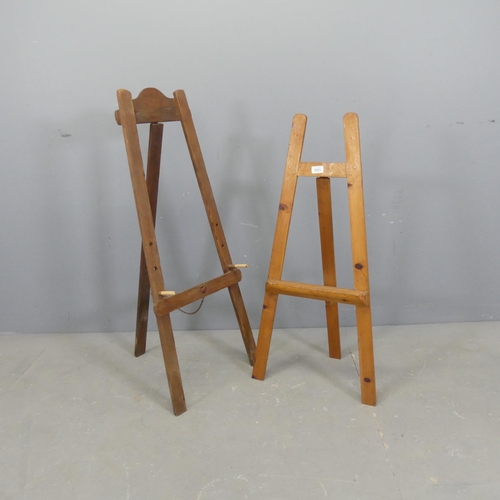 2551 - Two folding pine easels. Largest 42x102cm.