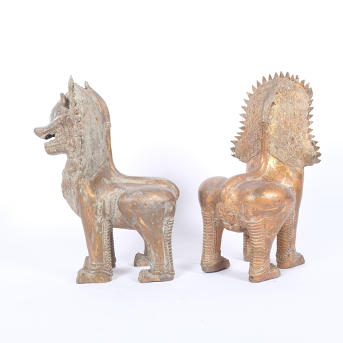 12 - A pair cast gilded metal temple lions, H31cm