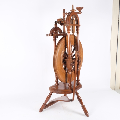 123 - An elm spinning wheel, H92cm