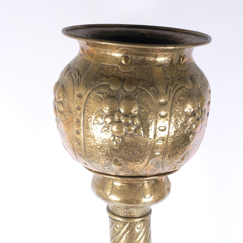 129 - A Victorian embossed copper jardiniere on stand, H127cm