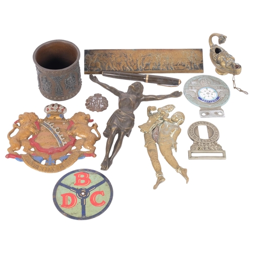 138 - A group of various items, including a bronze Corpus Christi, safe plaque, brass oil lamp, erotic bra... 