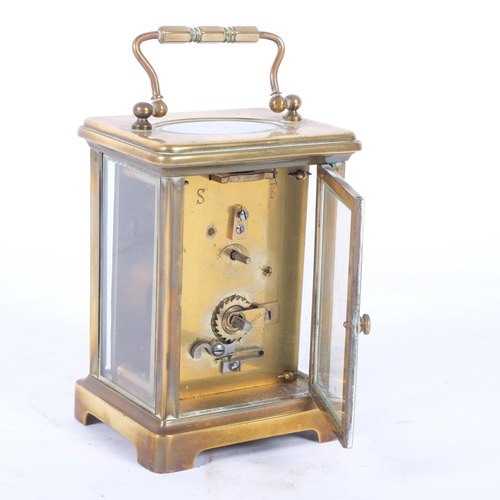 142 - VOKERS, BATH - a brass-cased carriage clock, height 11cm not including handle (currently not in work... 