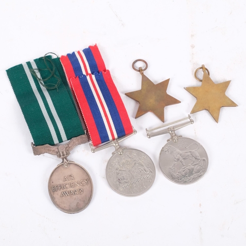 149 - A group of Second World War medals and ribbons, including Air Efficiency, with original box