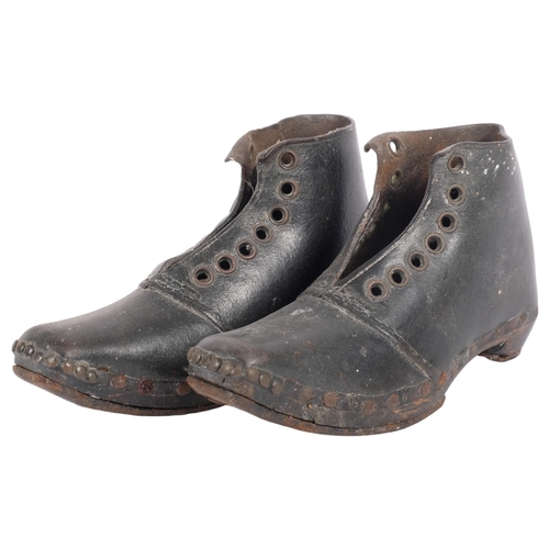 163 - A pair of small Georgian leather boots, with studded edge and steel bands to soles, overall length 1... 