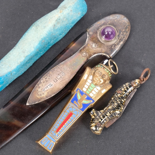 171 - A brass and enamel propelling pencil, in form of an Egyptian sarcophagus, a miniature shoe design pe... 