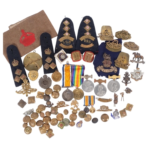 185 - A large collection of various military badges, buttons, epaulettes, etc