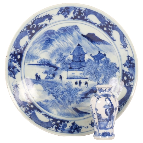 216 - A Chinese blue and white plate with pagoda decoration, diameter 26cm, and a small Chinese blue and w... 