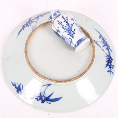 216 - A Chinese blue and white plate with pagoda decoration, diameter 26cm, and a small Chinese blue and w... 