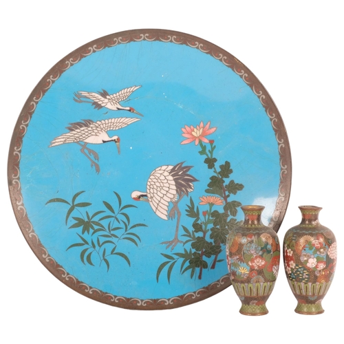 220 - A Chinese enamel plate with crane decoration, diameter 30cm, and a pair of small cloisonne fluted va... 