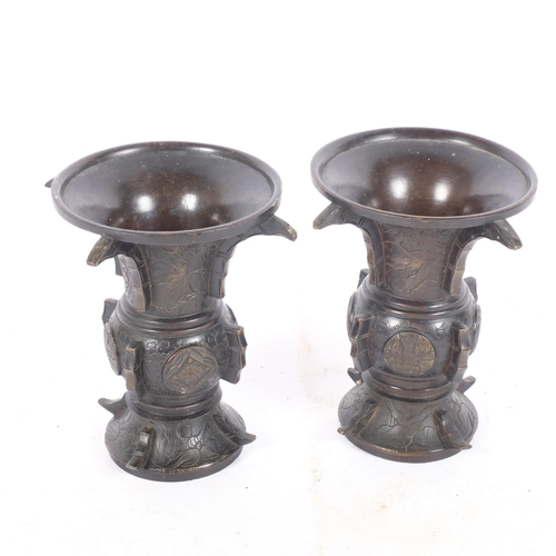 228 - A pair of Japanese temple vases, with raised and engraved decoration, H13cm