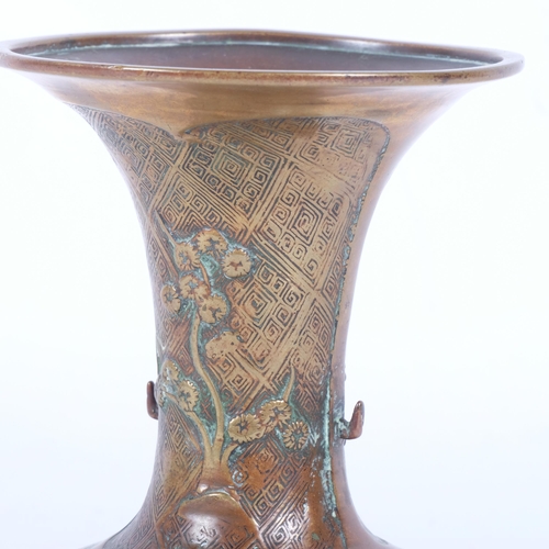 232 - A Chinese bronze vase of fluted form, lotus and blossom engraved decoration on foot, H16.5cm