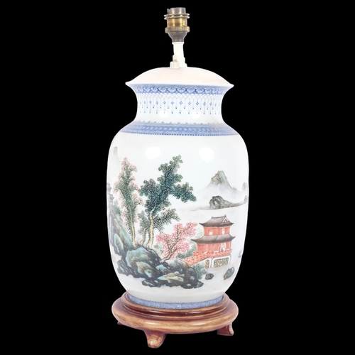 242 - A Chinese blue and white table lamp on turned wood stand, painted with pagoda and mountain decoratio... 