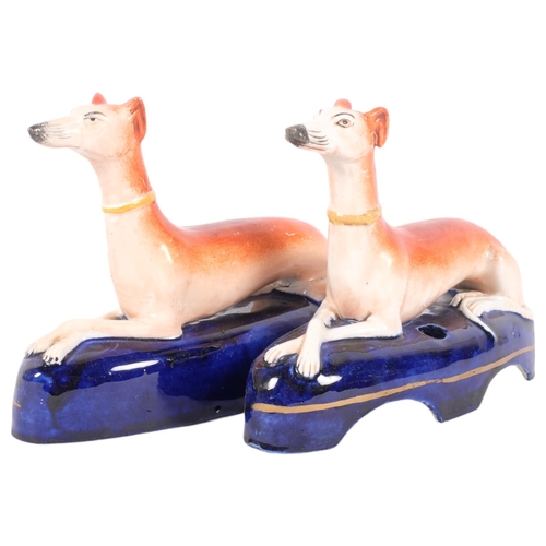 258 - A pair of Staffordshire inkwells surmounted by Greyhounds, H12cm