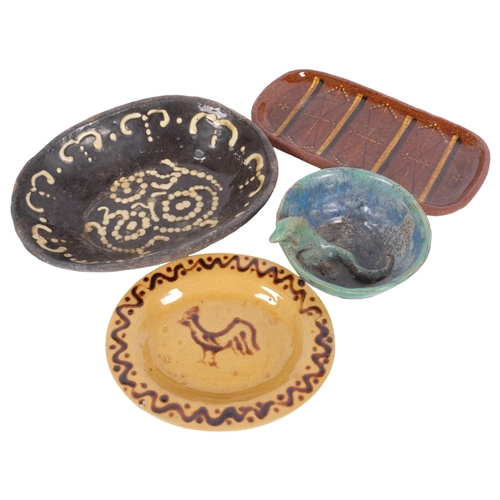 259 - A group of slipware pottery dishes and bowls, and a green glazed slipware bowl with applied lizard d... 