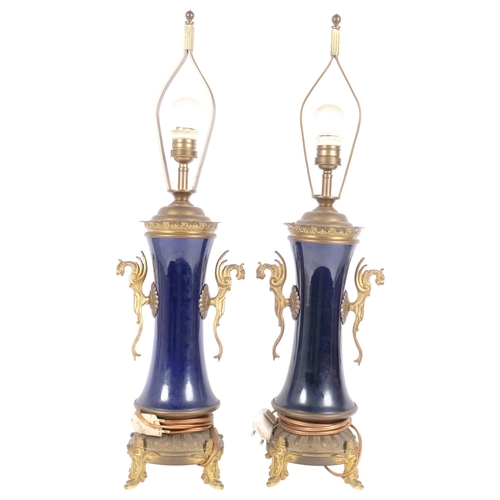 273 - A pair of Empire style blue enamel and gilt-brass table lamps, with figural mounts, height to top of... 