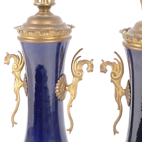 273 - A pair of Empire style blue enamel and gilt-brass table lamps, with figural mounts, height to top of... 