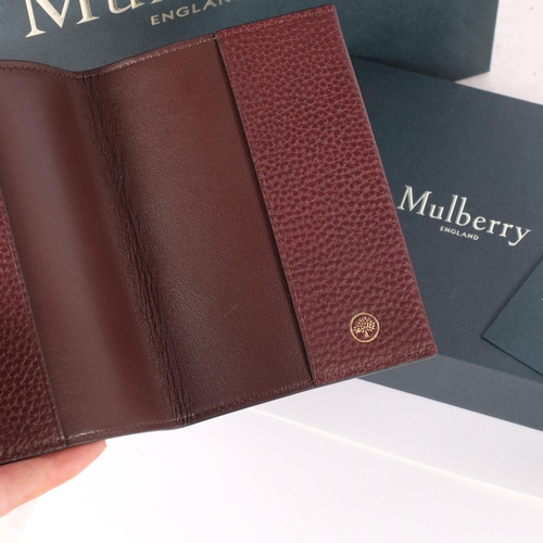 321 - MULBERRY - a leather passport cover, crafted from grained oxblood leather, opening to a smoother lea... 