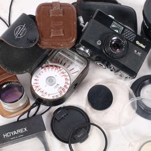 354 - A Rollei B35 and lens, in associated case, and a selection of other Vintage camera equipment