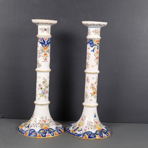 416 - A pair of Rouen faience painted candlesticks, 36cm