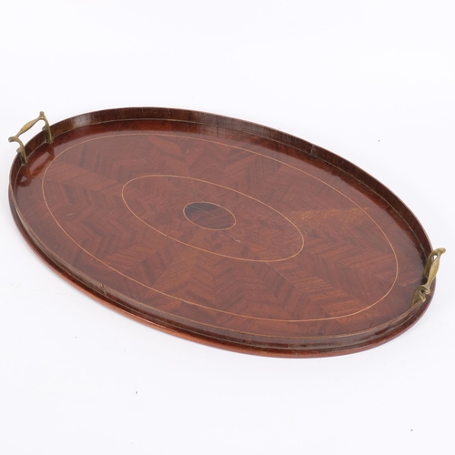 43 - An Edwardian mahogany oval galleried tea tray with brass handles, W66cm