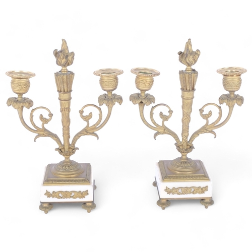 70 - A pair of Empire style gilt-brass 2-branch table candelabras, on white marble bases and gilt feet, H... 