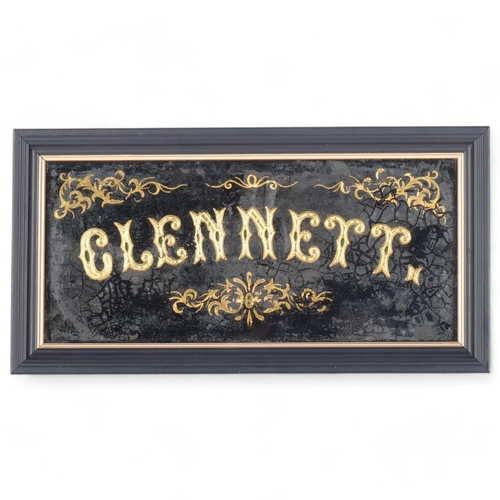 74 - Clennett, a gilt applied sign mounted in glass frame, 15.6cm x 30cm