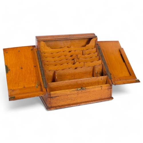 84 - A Victorian oak desk-top stationery box, the 2 fold-out lids revealing a stepped fitted interior and... 