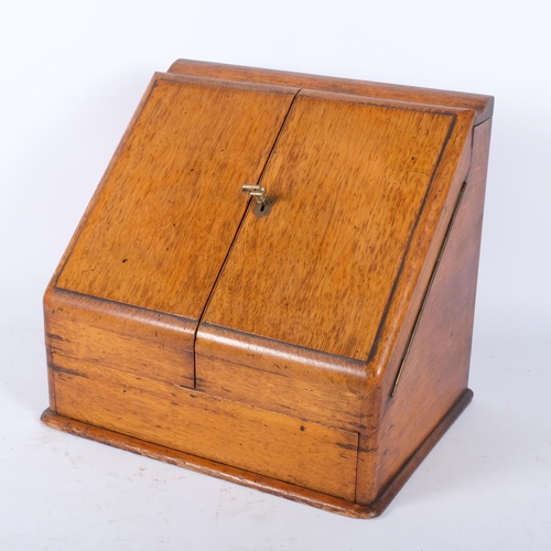 84 - A Victorian oak desk-top stationery box, the 2 fold-out lids revealing a stepped fitted interior and... 