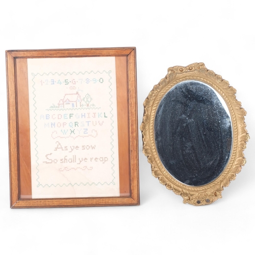 90 - A needlework sampler, framed, and a gilt plaster framed wall mirror (2)